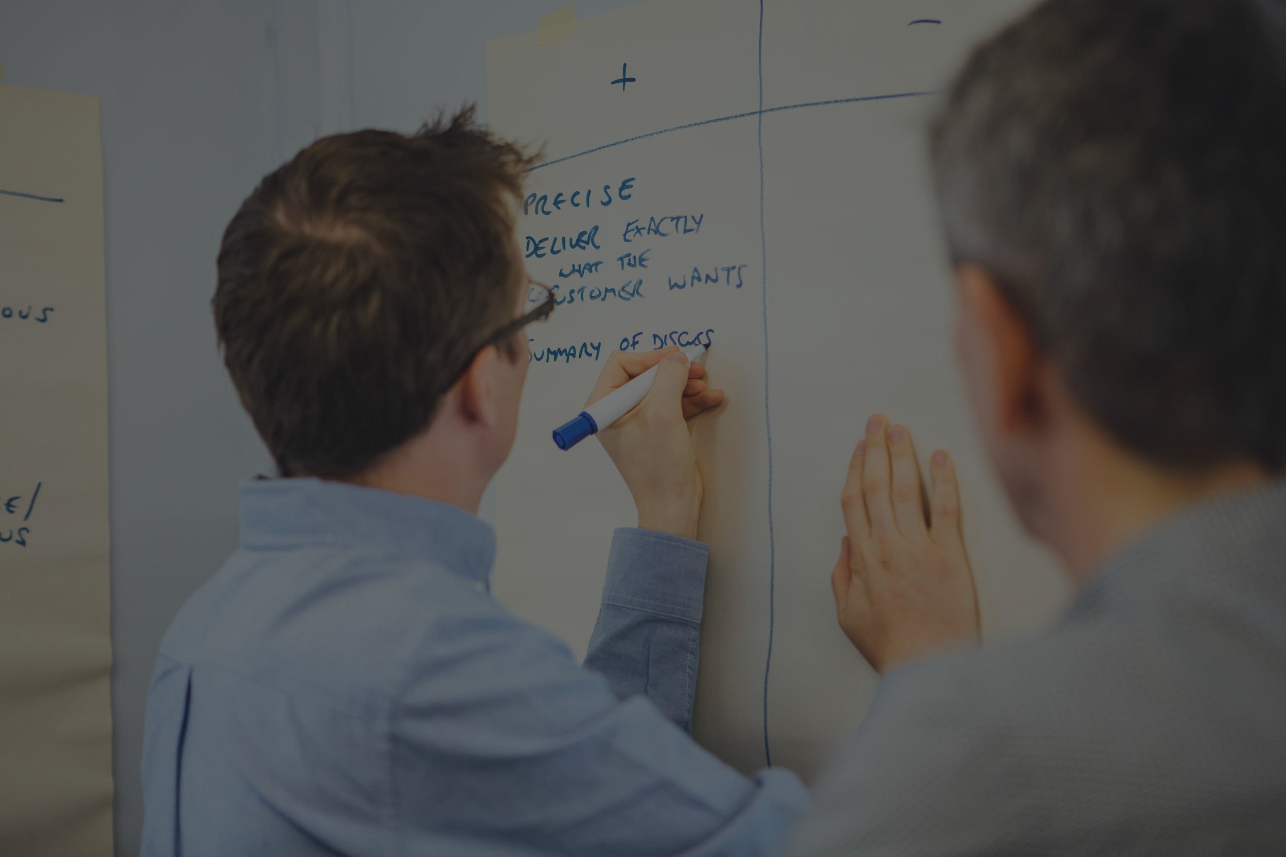 Digital marketing executive writing on whiteboard