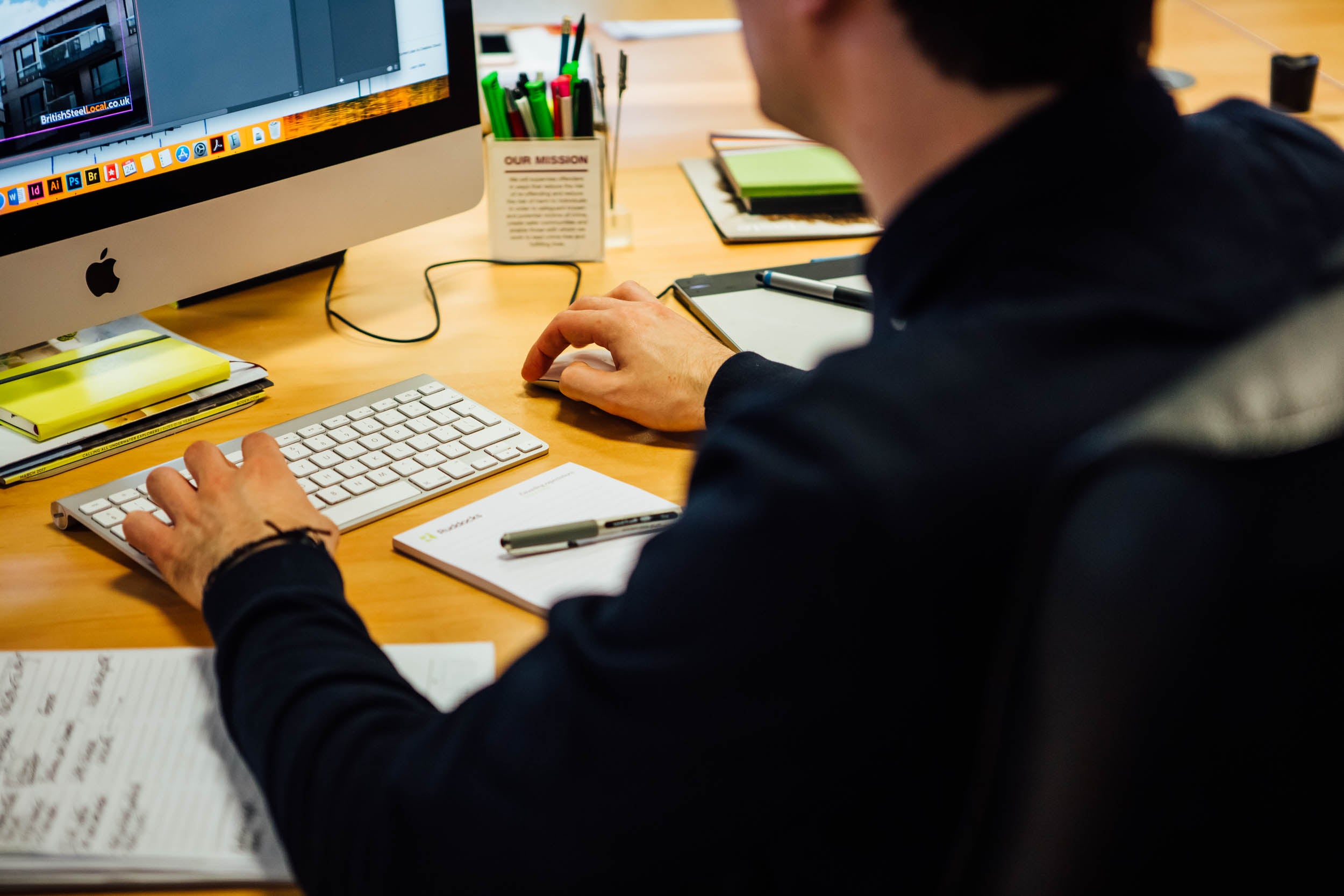 A designer working at their desk 