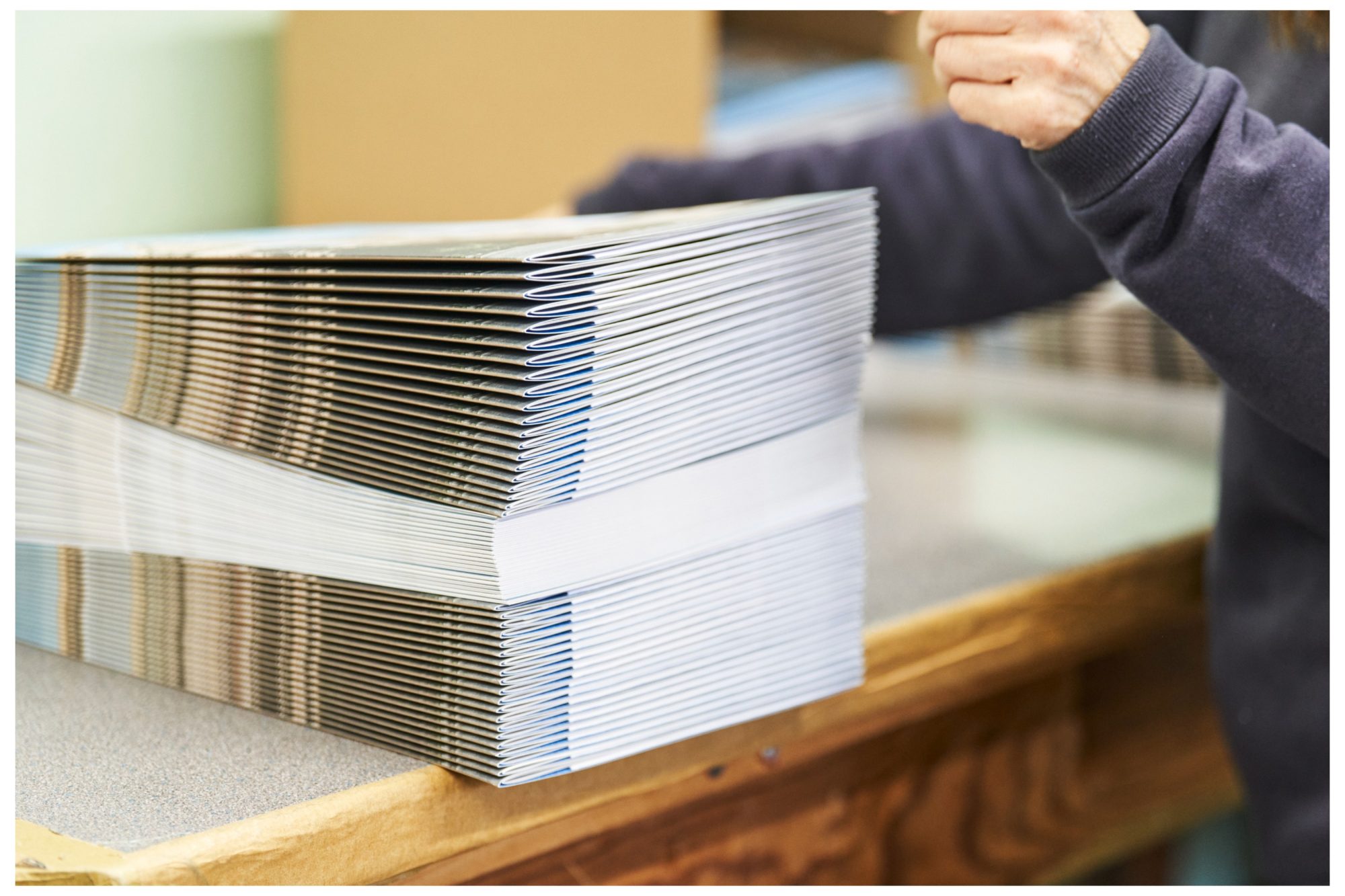 A hand sorting brochures